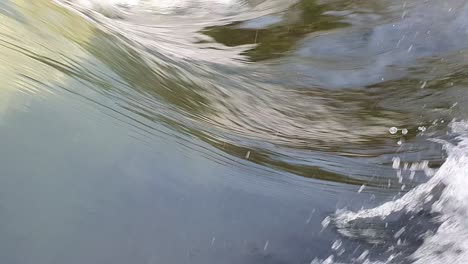close up of fresh water streaming over a weir, abstract and mesmerizing