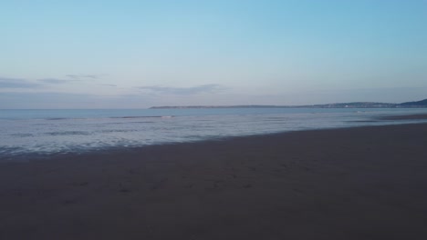 Sunrise-Cinematic-Aerial-of-Aberavon-Beach-with-Swansea-in-Distance