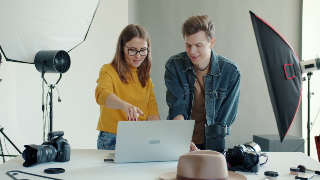 Two photographers collaborating in a studio