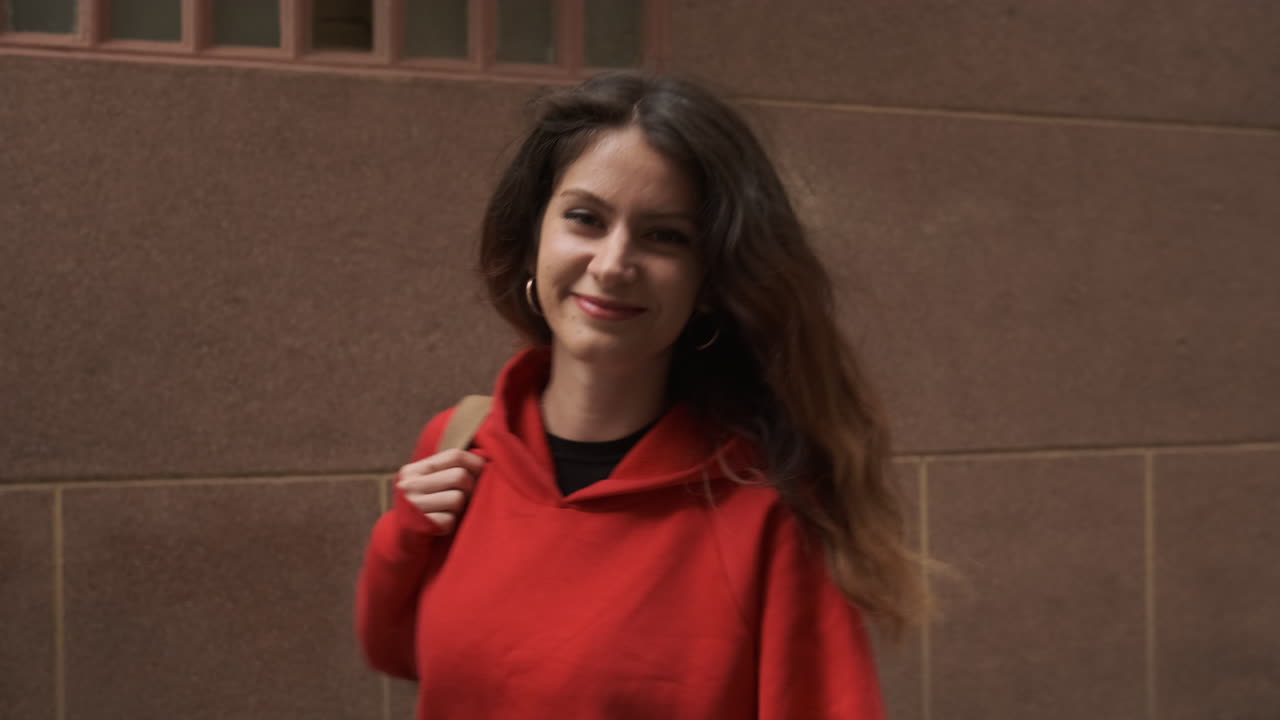 Young girl smiling and looking at the camera in the street