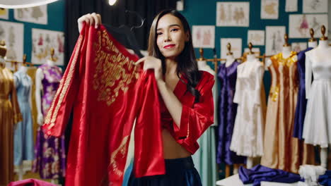 asian fashion designer showcasing intricate traditional dress