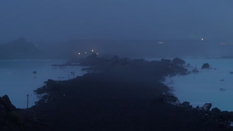 iceland, blue lagoon, svartsengi geothermal power station at night, fog rolling over the blue water, no camera movement