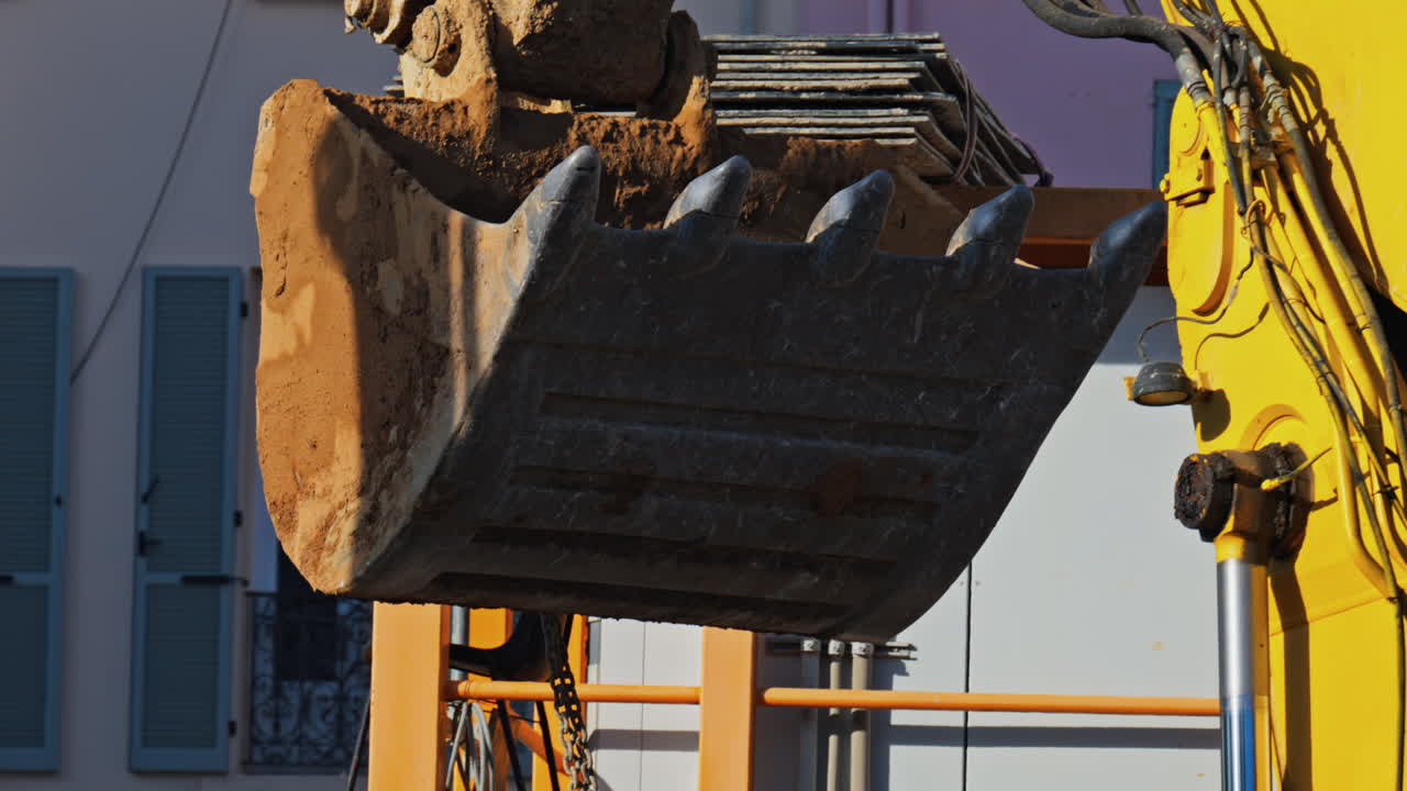 Close up of a yellow crane machine moving and lifting on a construction site
