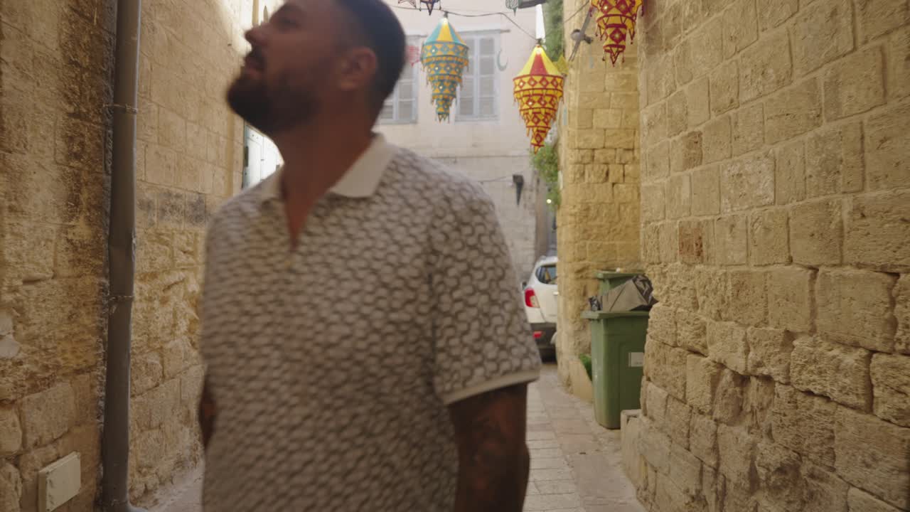 Tourist photographer walking picturesque alley in old town Nazareth