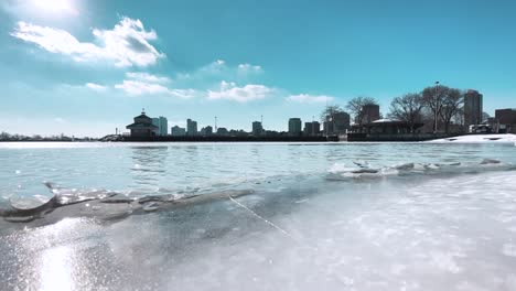 flowing water on icy lake michigan against the milwaukee skyline and blue sky