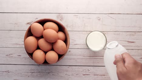 eggs and milk on a wooden table