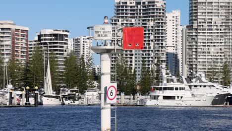 a boat moves past a harbour sign