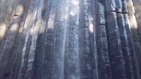 waterfall from the basalt prisms geological formation, san miguel regla, mexico