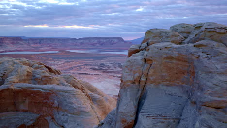 a sweeping view unveils the timeworn formations of glen canyon, with the waters of lake powell shimmering nearby.