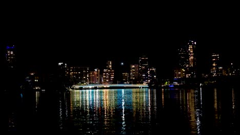 city lights reflecting on water at night