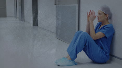 animation of moving shapes over sad caucasian female nurse sitting in hospital