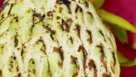 detailed view of vibrant dragon fruit and textured cherimoya with hints of persimmon.