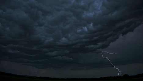 Dramatic video still of a stormy sky with lightning, captured from a low-angle perspective