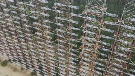 rusty duga antenna at the radar station in chernobyl, pripyat, ukraine - approaching drone shot