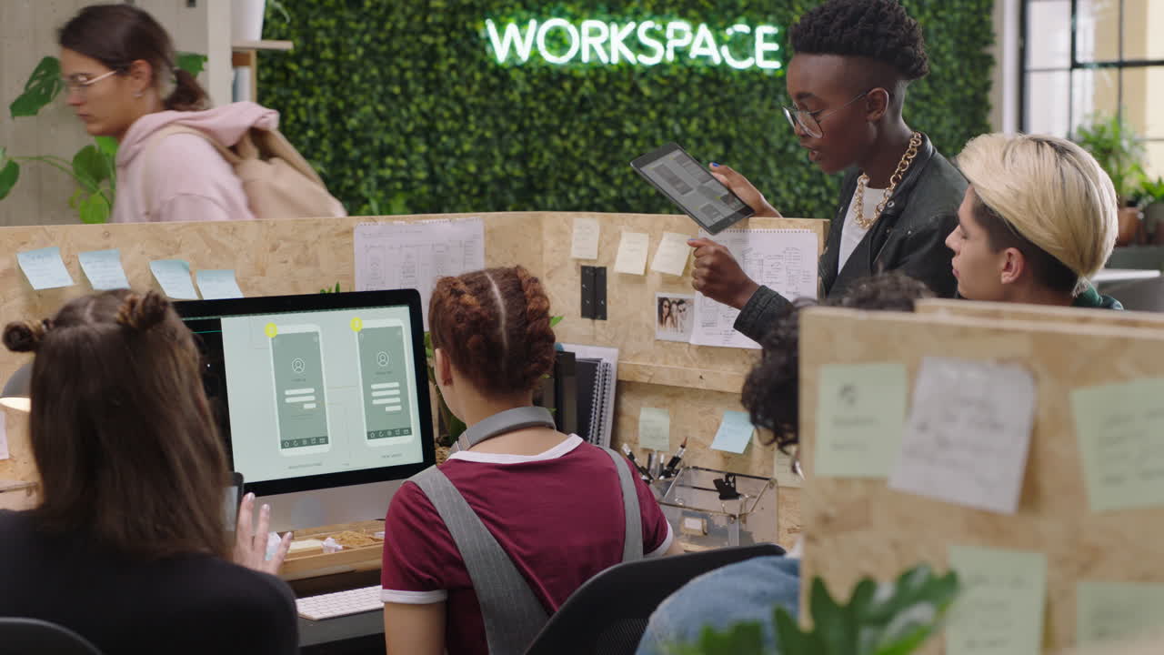 young business people meeting software developer team design mobile application diverse group of students brainstorming sharing creative ideas for communication app using computer in trendy office