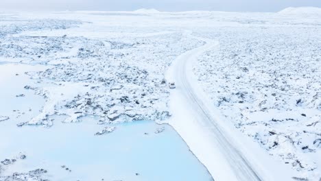 winter wonderland at blue volcanic pools covered with snow in iceland