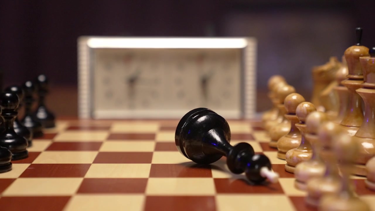 Hand Knocks Over Black Chess King in Slow Motion