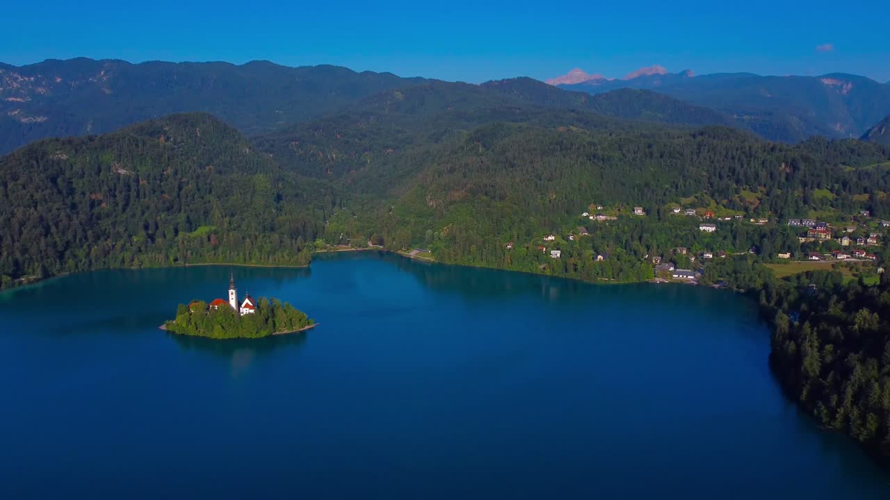 4K drone view of Lake Bled Island in the distance - Lake Bled, Slovenia