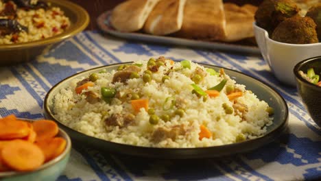 sprinkling pepper on couscous with chicken on table close-up. arabian cuisine. pita and bulgur on background. traditional middle eastern culture. delicious rice with meat. homemade food concept