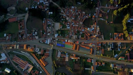 Top-Down-View-Over-Poroy-in-Peru-with-Warm-Sunlight-Over-Buildings-and-Roads