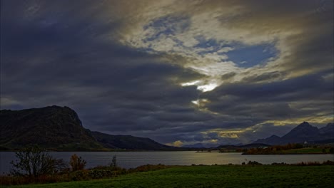 panoramic view of a lake surrounded by mountains on a cloudy day in late autumn