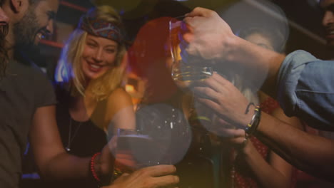 multi ethnic friends clinking glasses at party
