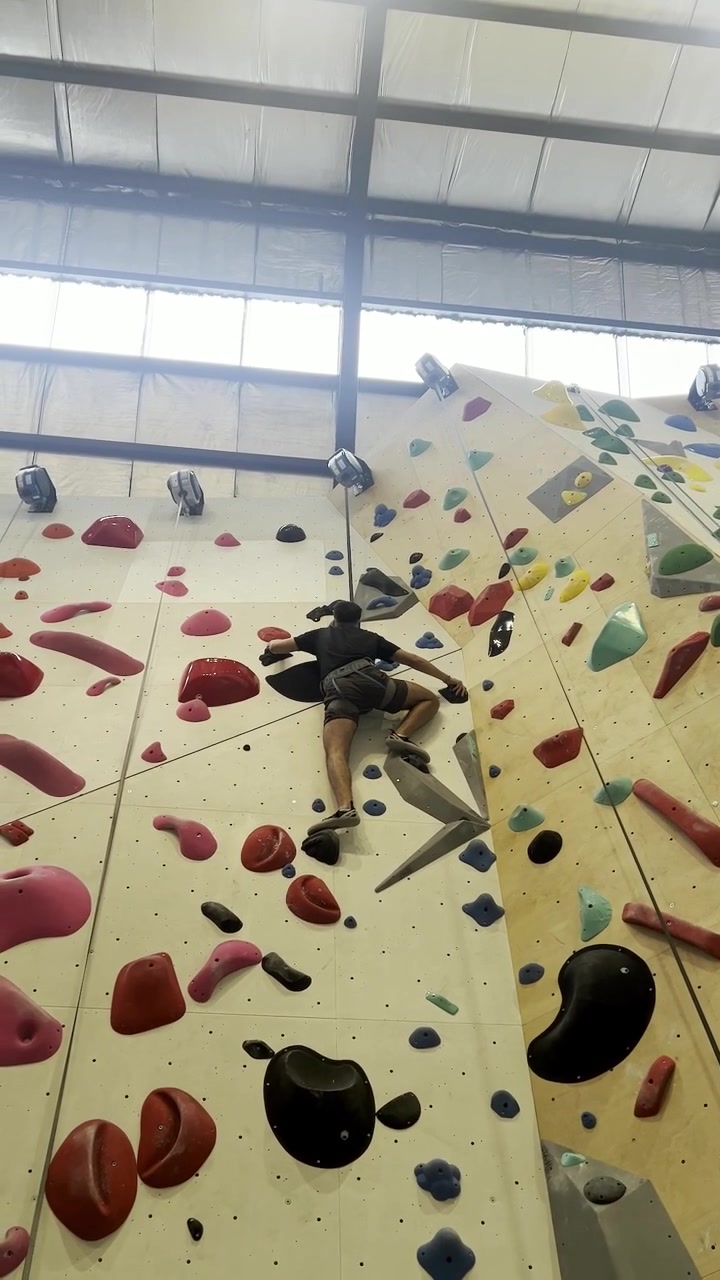 A climber pushes upward through a difficult section of the route