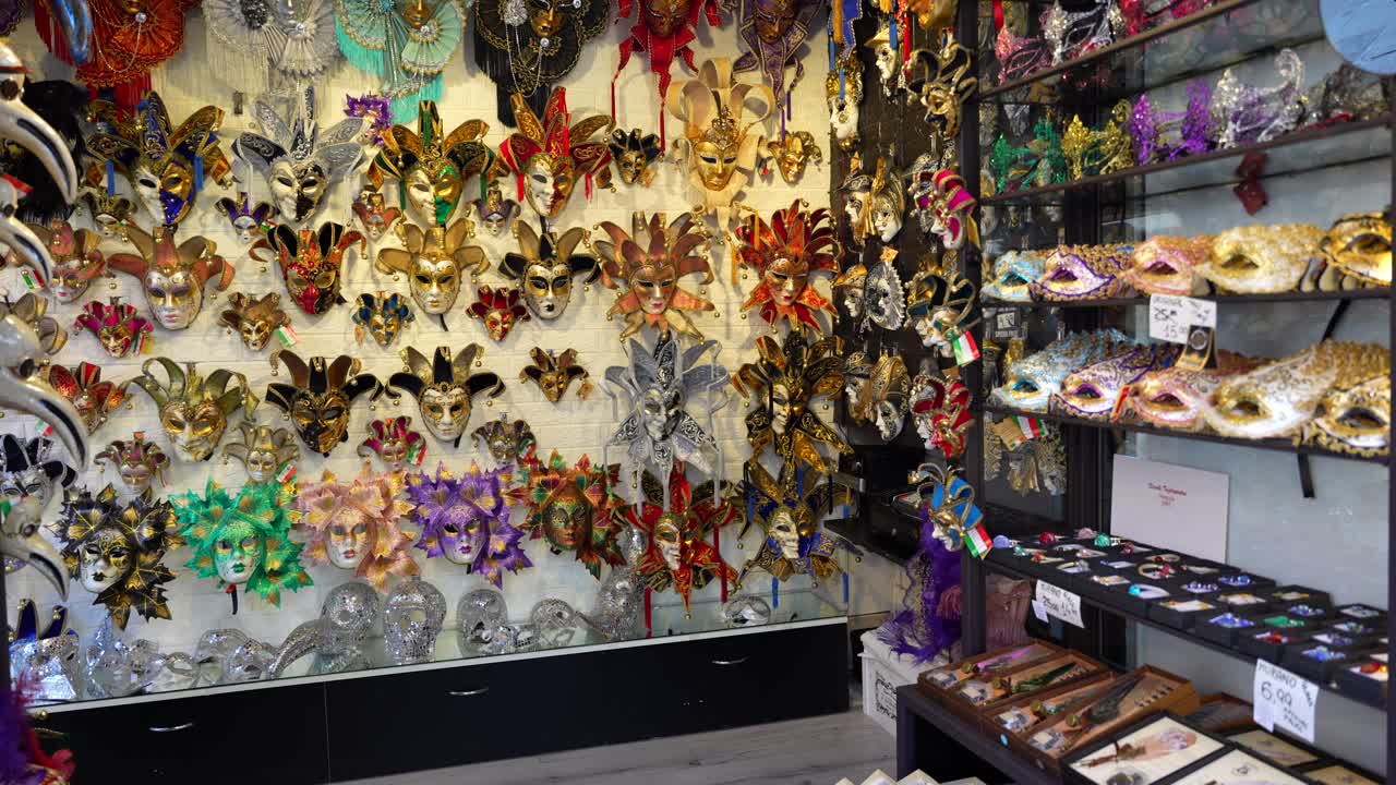 Venetian masks hanging in shop for Carnival festivities in Venice, Italy
