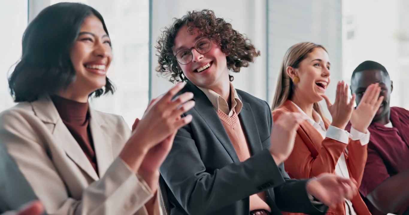 Diverse Group of Professionals Applauding and Laughing in Office Meeting