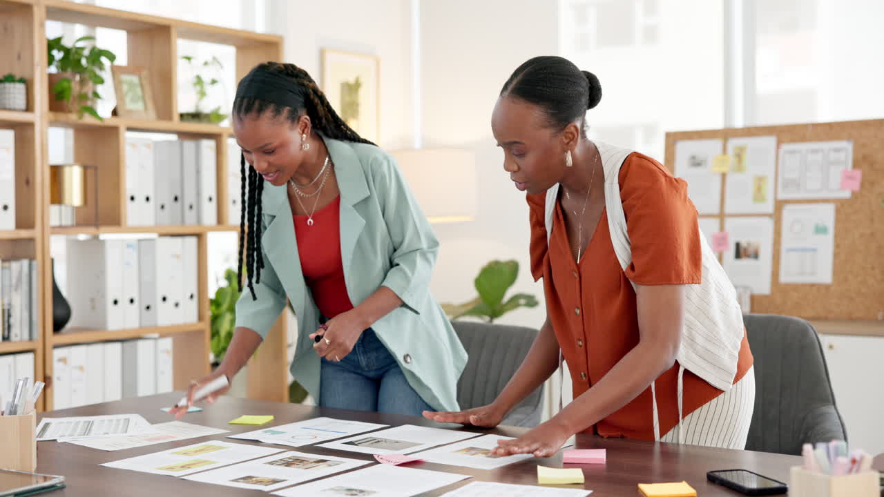 Two Businesswomen Collaborating and Planning a Project in a Modern Office