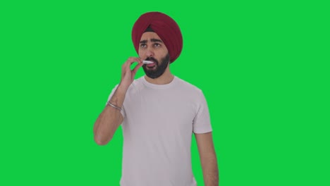 sick sikh indian man using thermometer to check fever green screen