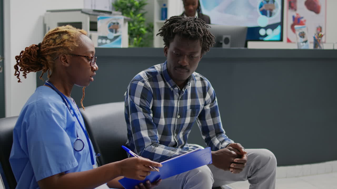 Medical assistant explaining diagnosis to sick man