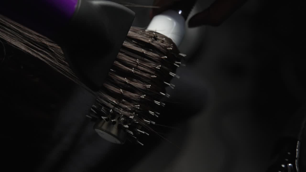 hair drying with a comb woman dark hair