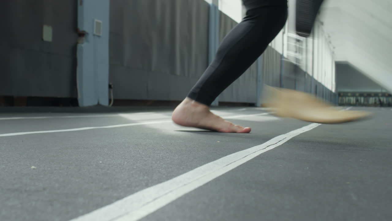 Legs of Athlete with Prosthetic Limb Training Agility