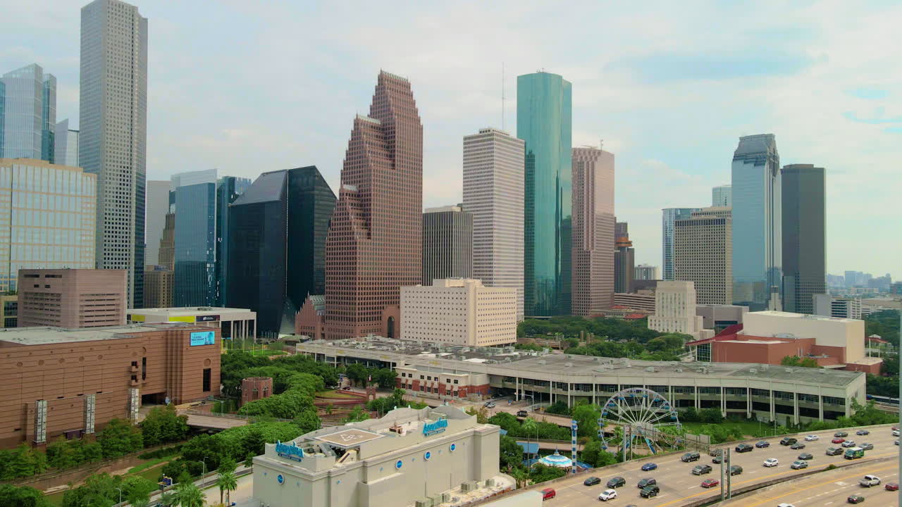 Establishing Parallax aerial shoot Houston Downtown in rush hour traffic on the interstate freeway 45