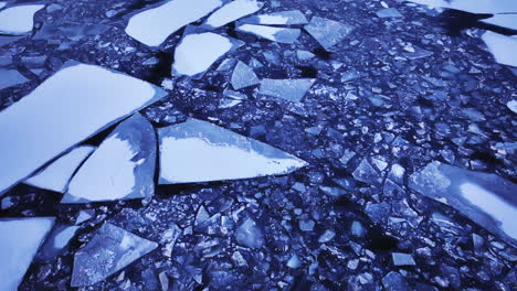 drone shot flying over large chunks of ice