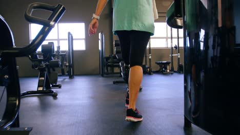 senior woman walking in fitness studio 4k