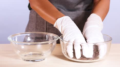 hands sorting chocolate chips into glass bowls