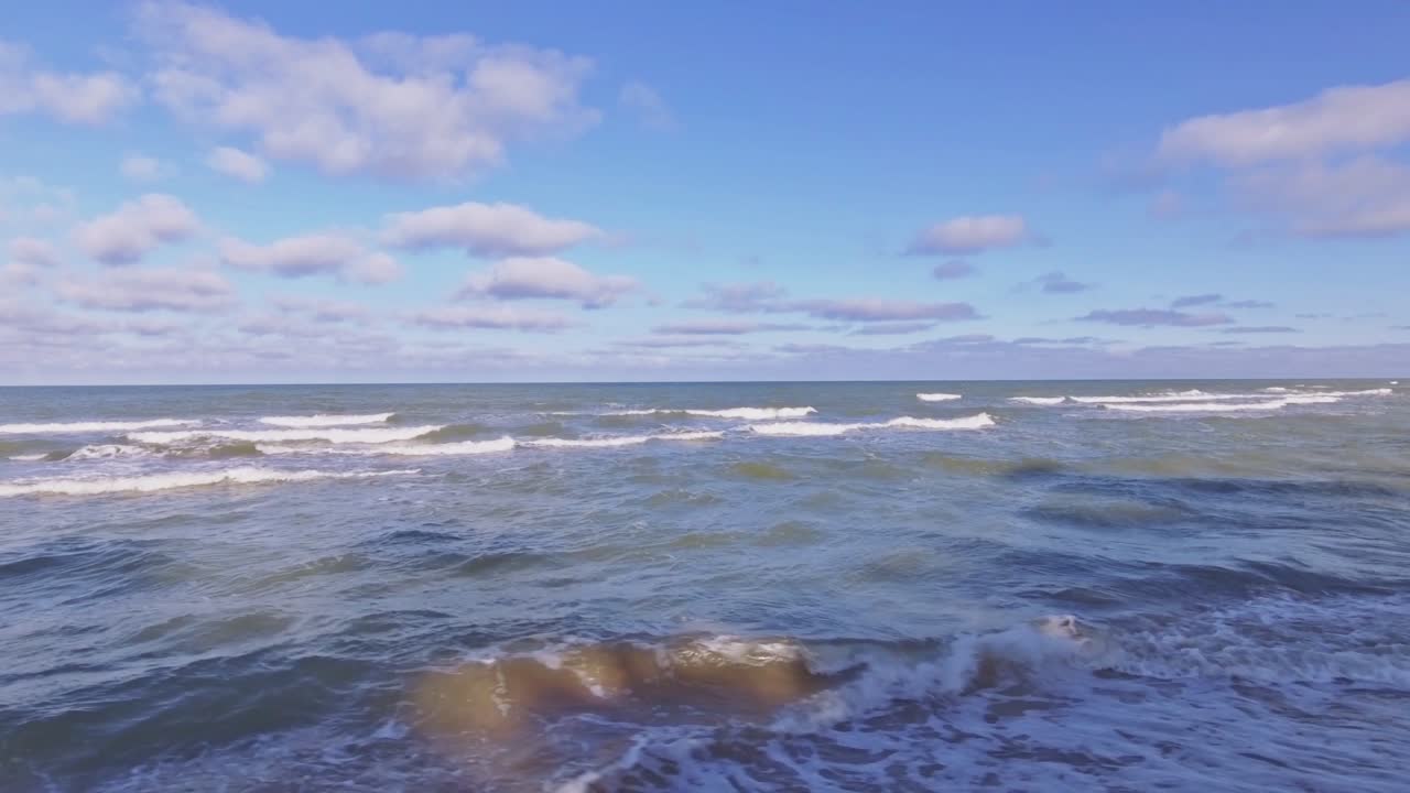 Baltic Sea Waves Rinse Seaside Beach At Sunrise. Aerial Low Track Left