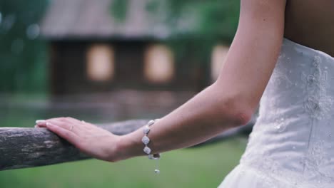 bride resting hand on a wooden fence