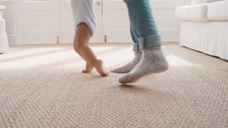 baby taking first steps toddler learning to walk with father helping infant teaching child at home fatherhood support