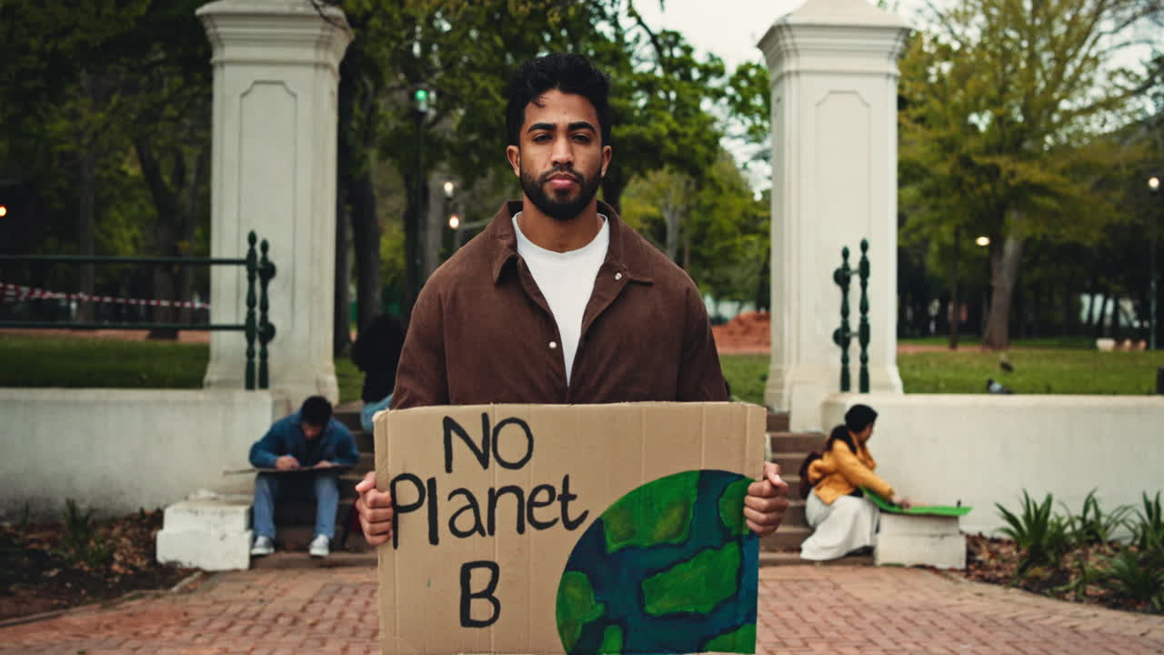 Young Man Holding 'No Planet B' Protest Sign