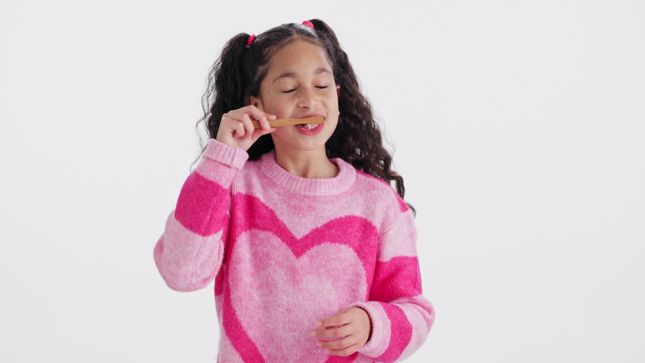 Girl brushing her teeth with a toothbrush