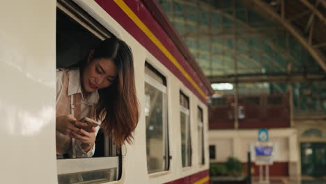 woman taking a picture of the train station