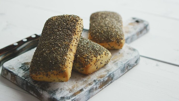 Closeup of whole grain bread with seeds on a rustic wooden board