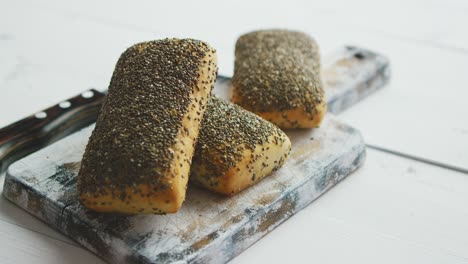 closeup of whole grain bread with seeds on a rustic wooden board