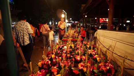 decorative krathong rafts laid out ready to sell during the loi krathong festival in bangkok, thailand. loy krathongs made out of banana leaves and flowers on the counter for selling, holidays in asia