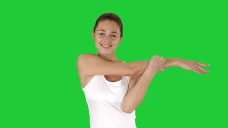 woman happy smiling woman stretching arms while walking on a green screen, chroma key
