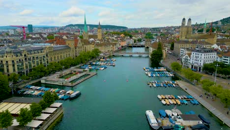 4k drone video of traffic and trains on the quaibrücke bridge over the limmat river in downtown zurich, switzerland