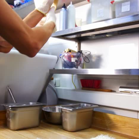 restaurant chef is working. hands are shaping floured dough for pizza. experienced cooker making pizza using traditional recipe. modern kitchen background